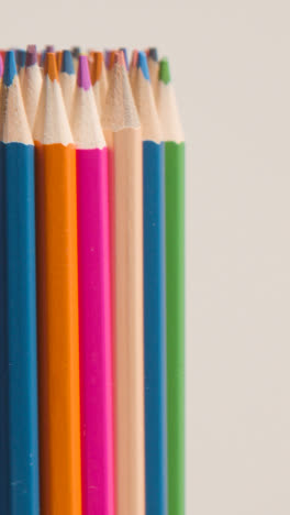 Vertical-Video-Studio-Shot-Of-Rotating-Multi-Coloured-Pencils-Against-White-Background-1